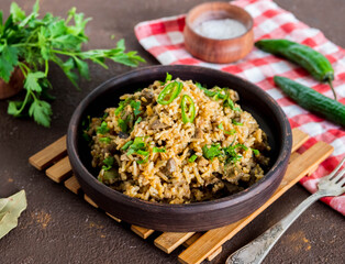 Dirty rice, Cajun cuisine dish, rice with liver, minced pork, green pepper and spices in a clay...