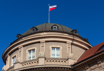 Polish national flag against the blue sky.