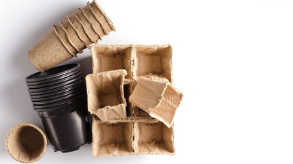 Different pots for planting and growing plants at home. Peat vases, plastic of different shapes, copying of space, flat layout