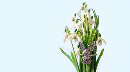 snowdrops and metallic decorative rabbit, symbol Ostara or Easter holiday. festive spring season....