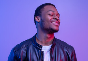 Obraz premium Closeup Of Satisfied Black Guy In Leather Jacket Standing With Closed Eyes