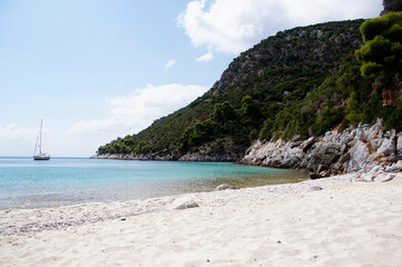 A view of the sandy Limnonari beach, sea and surrounding heels. Skopelos, Greece