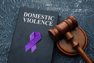 Domestic violence law and gavel on grey table.