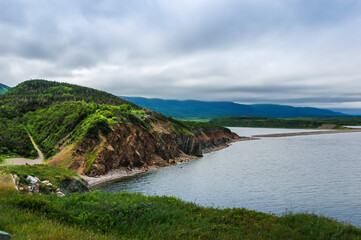 Fototapeta na wymiar A rock cliff on the shore in Cape Breton Island Nova Scotia Canada.