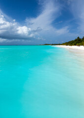tropical Maldives island with white sandy beach and sea