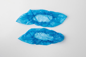 the pair of blue overshoe or shoecovers on the color surface isolated
