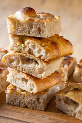 A beautiful traditional focaccia cut into pieces. Focaccia of natural sourdough