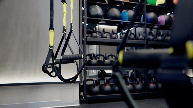 Balls and kettlebells and trx system in modern gym.