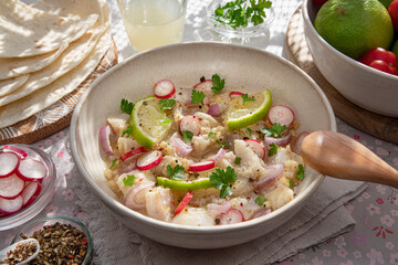 Close-up of a Peruvian ceviche with pieces of fish and lemons