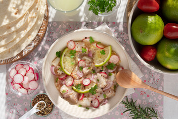 Close-up of a Peruvian ceviche with pieces of fish and lemons