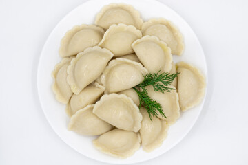 Fototapeta na wymiar Boiled dumplings with potatoes. Traditional Ukrainian and Russian food. White background.