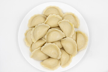 Fototapeta na wymiar Boiled dumplings with potatoes. Traditional Ukrainian and Russian food. White background.