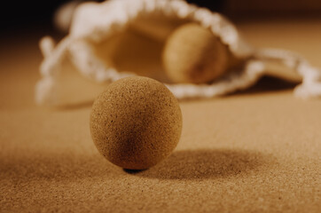 Close up of fascia release cork massage ball a cork mat background, warm golden light. Concept: eco...