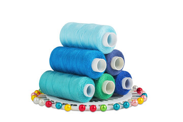Sewing threads and needle, bobbins in blue  color on isolated white  background