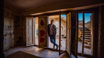 Guy standing in the old abandoned building