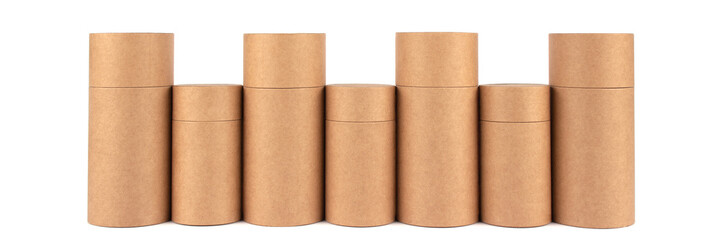 Different recyclable paper tubes, cardboard containers with paper caps for cosmetic or other packaging isolated on white background, mockup. Zero waste packaging concept. Selective focus. Banner