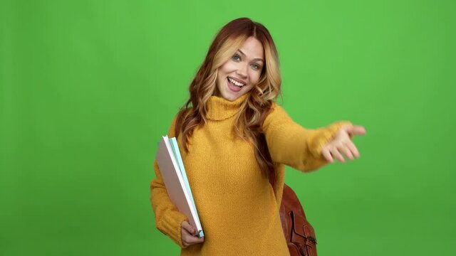 Teenager woman with backpack presenting and inviting to come with hand over isolated background chroma key