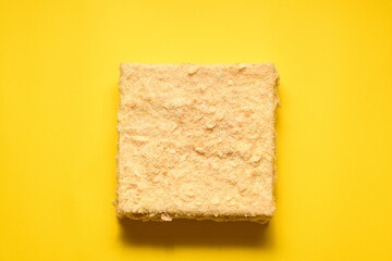 Napoleon cake on a yellow background. Filmed from above. Place for a logo.