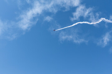 Vintage biplane does loop stunt with smoke trails. airplane