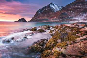 Sunset Norway landscape of picturesque stones on the arctic beach of cold Norwegian Sea