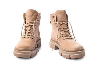 Pair of beige fashion leather boots isolated on white