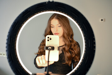 Girl having fun creating videos using beauty skincare mask - Young woman streaming online using...