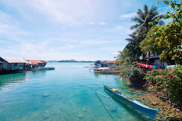 Beautiful landscape with blue sea, tropical islands and fishing houses on stilts in mangrove lagoon, Siargao Island, Philippines.