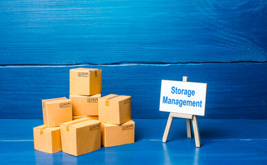 Pile of boxes and storage management easel. A set of measures for the effective organization of...