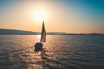 Regatta sailing ship yachts with white sails at opened sea. Aerial view of sailboat in windy...