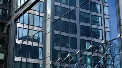 Fragment of glass and metal facade walls. Commercial office buildings. Abstract modern business architecture.