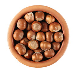 Hazelnuts in clay pot isolated on white background, top view