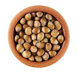 Hazelnuts in clay pot isolated on white background, top view