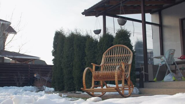 Rocking chair yard winter snow push out backward camera movement