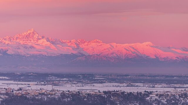 Pan: unique landscape of high altitude snow capped mountain range in Piedmont, Italy. Monte Viso mountain peak. Epic sunrise light in winter, dramatic sky.