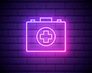 Glowing neon line First aid kit icon isolated on brick wall background. Medical box with cross. Medical equipment for emergency. Healthcare concept. Vector Illustration