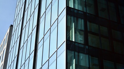 Fragment of glass and metal facade walls. Commercial office buildings. Abstract modern business architecture.