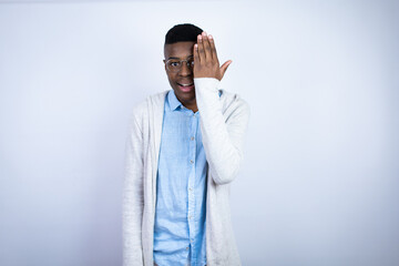 Young handsome african american man wearing casual clothes covering one eye with hand, confident...