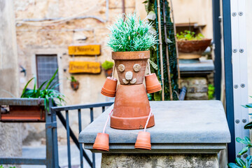 Funny sculpture made of flower vases and corks in the historical center of Campiglia Marittima, Tuscany, Italy. DIY ideas for home and garden decoration.