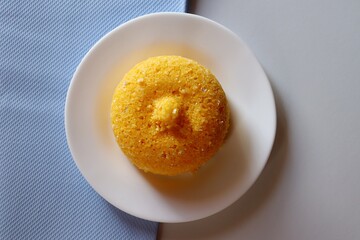 Brazilian Couscous on white and blue background, with copy space. Corn couscous. 
