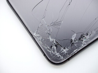 The angle of back space grey modern smartphone has broken glass on white background. Modern smartphone with damaged back glass.