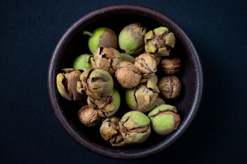 walnuts in shell in clay dish
