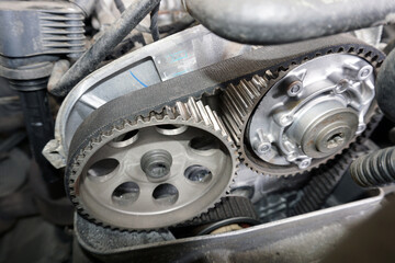 Timing of a modern car. Toothed belt and cogwheels. Selected focus, background blurred.