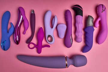 Collection Of Bright Purple Dildos Vibrators Sex Toys On Pink Background, Beautiful Cute Clitoral...