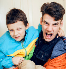 young handsome father with his son fooling around at home, lifestyle people concept