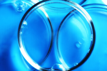Abstract medical cosmetology blue background from glass petri dishes.
