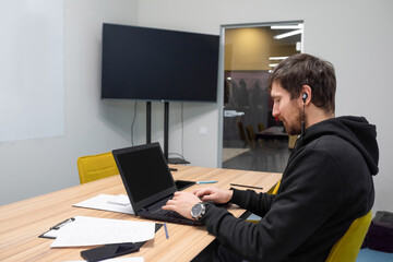 Young businessman working at his desk, office laptop. Business, consultations, online training, coworking