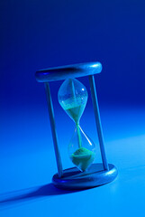 Hourglass on infinite colorful background, marking the time of the game. An old way of counting...