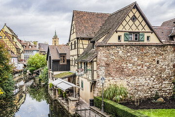 Fototapeta na wymiar Petite Venice - water canal and traditional half-timbered houses in Colmar old town. Colmar is a charming town in Alsace, France.