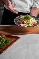 Unrecognizable Chef in Unifrom Showing Dish Prepared By Him, Representing Delicious Food At Master Class. Cropped Male In Uniform