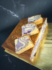 Blueberry butter cake with slices on white plate. Selective focus points